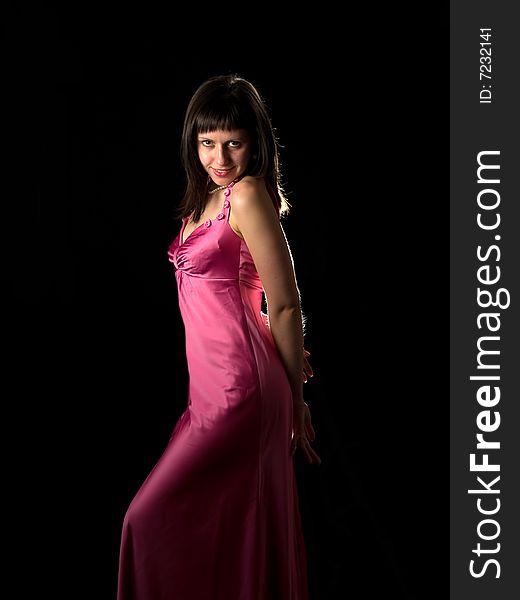 Attractive lady in pink silk dress smiling