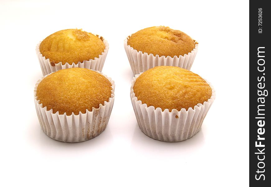 Magdalenas, sponge cakes 	
isolated on a white background