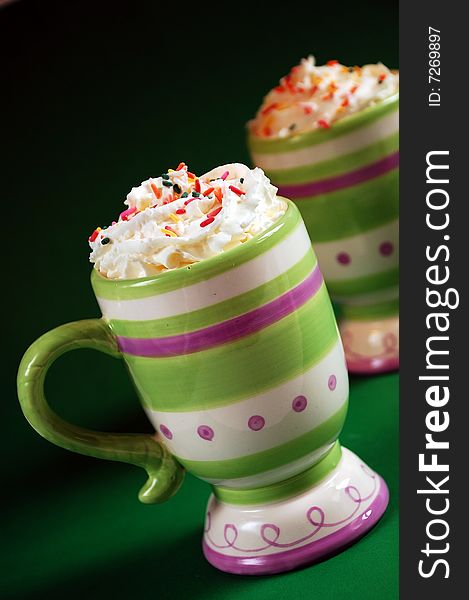 Colorful striped mug of hot cocoa and whipped cream