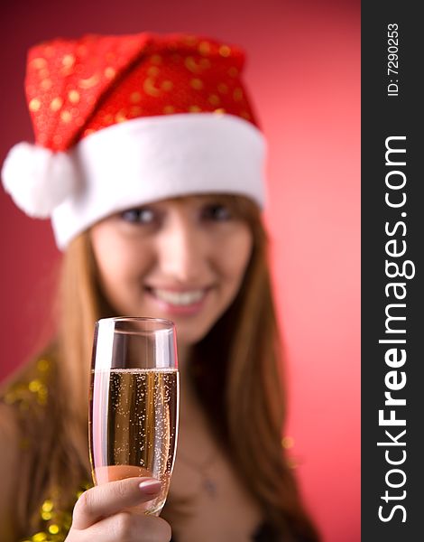 Mrs. Santa with champagne, focus on glass