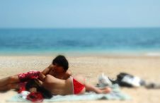 A Cute Couple Cuddles On An Italian Beach Stock Photo