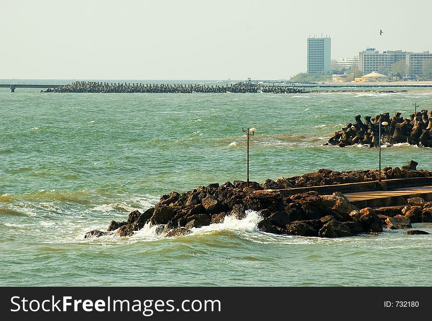 Black Sea with extended jetties and resort on shoreline at Olimp resort in Romania. Black Sea with extended jetties and resort on shoreline at Olimp resort in Romania.