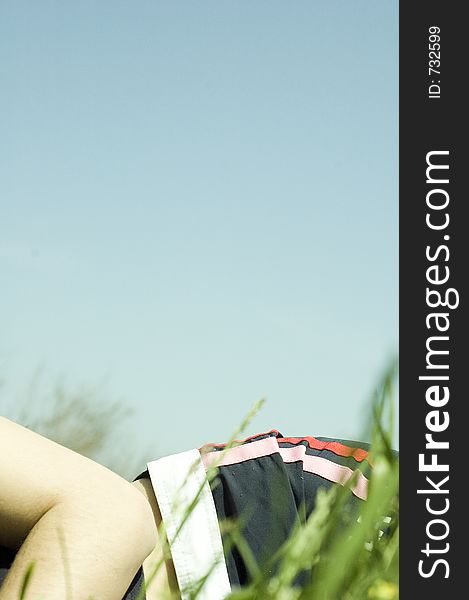 Lying down in grass near the shore (portrait frame). Lying down in grass near the shore (portrait frame)