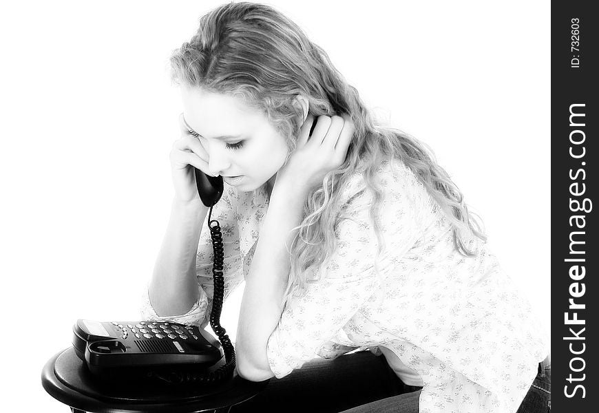 Pretty female teen talking on a telephone. Black and white. Pretty female teen talking on a telephone. Black and white.