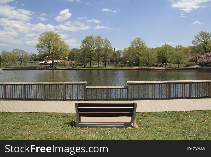 Empty bench at a NJ park lake. Empty bench at a NJ park lake