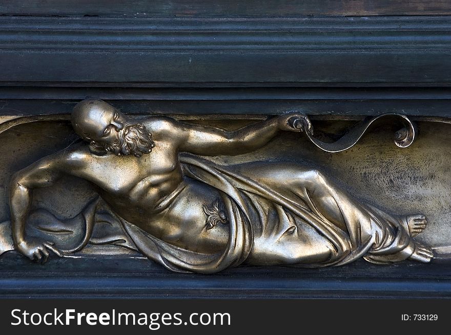 A religious icon on a brass church door. A religious icon on a brass church door.