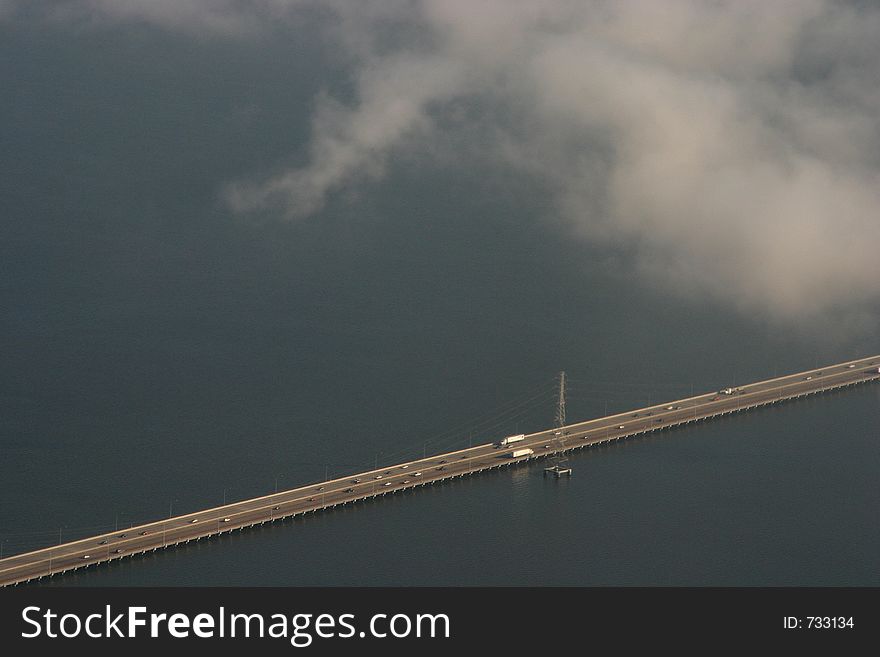 A low bridge over San Francisco bay with light traffic. A low bridge over San Francisco bay with light traffic.