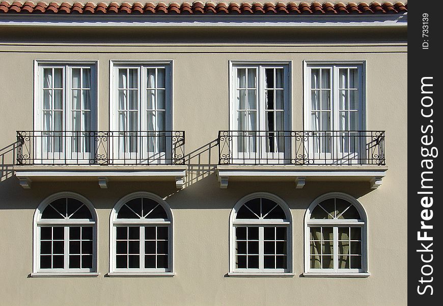 The side of a house with old fashioned windows. The side of a house with old fashioned windows.