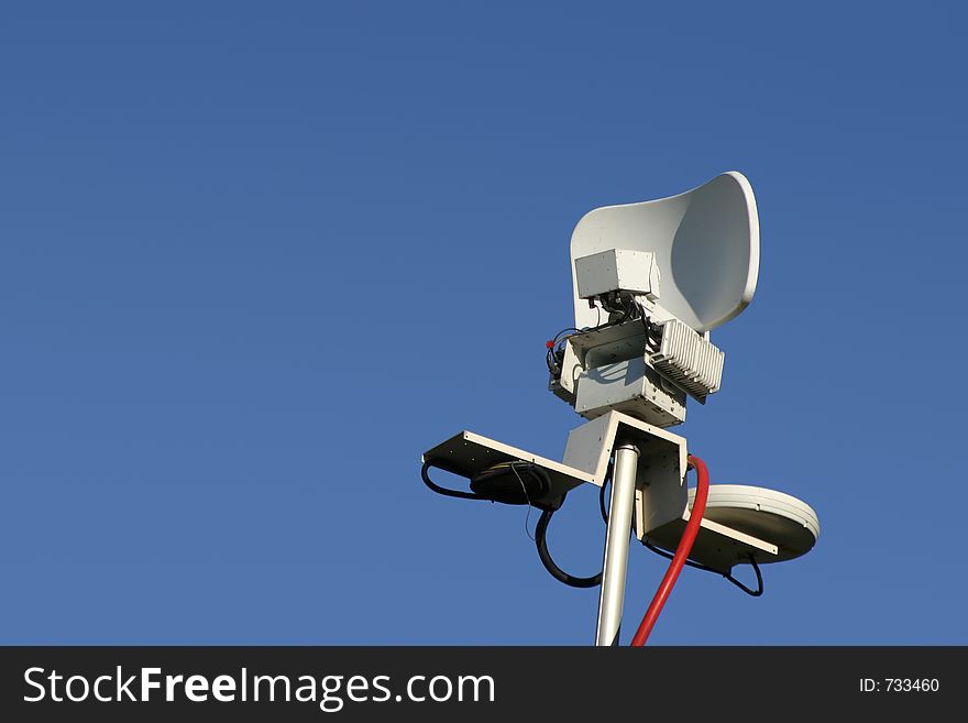 The microwave dish antenna on top of the remote news van mast. The microwave dish antenna on top of the remote news van mast.