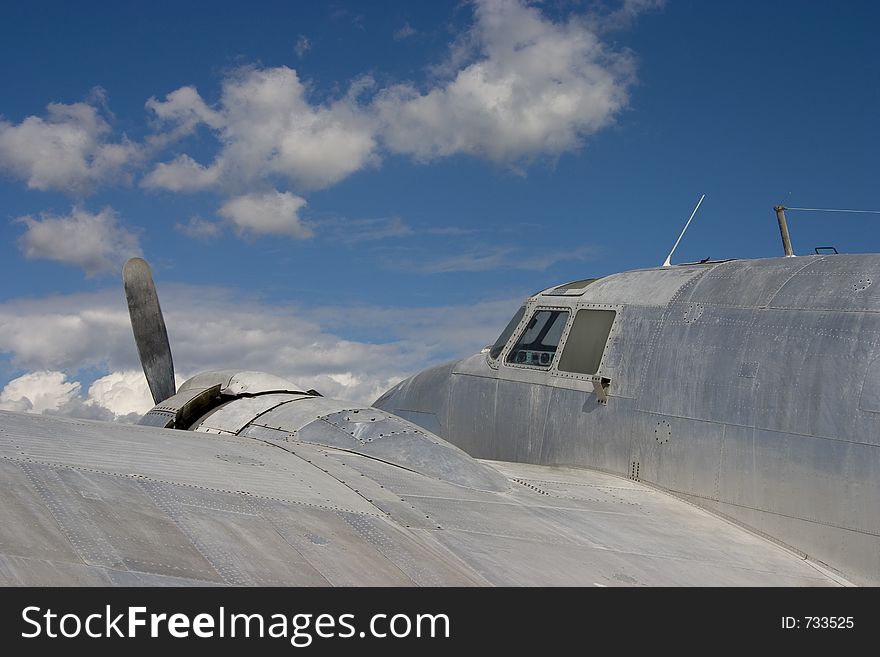 An old prop plane against a blue sky. An old prop plane against a blue sky.