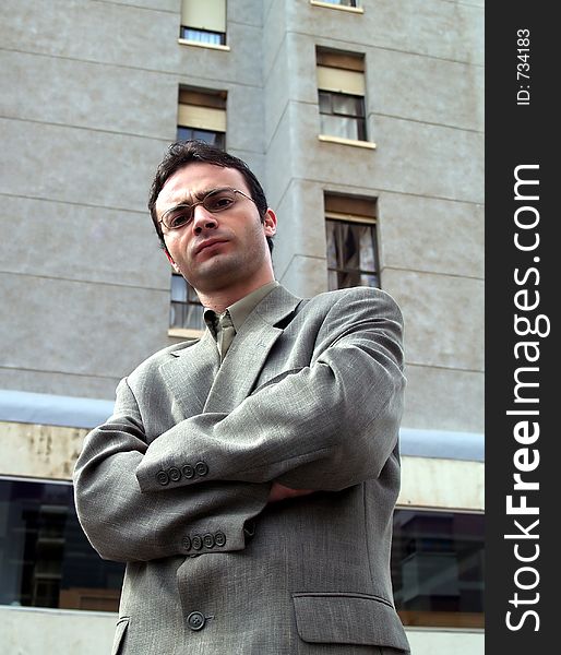 Businessman standing in front of a building. Businessman standing in front of a building