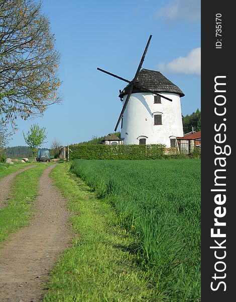 Windmill in a countryside, beside a country road