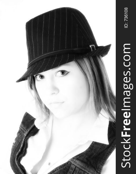 Black and white close up of beautiful young woman in pin striped hat.