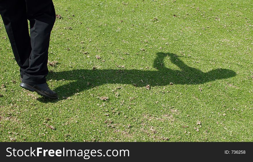 Golfer's shadow during swing. Golfer's shadow during swing