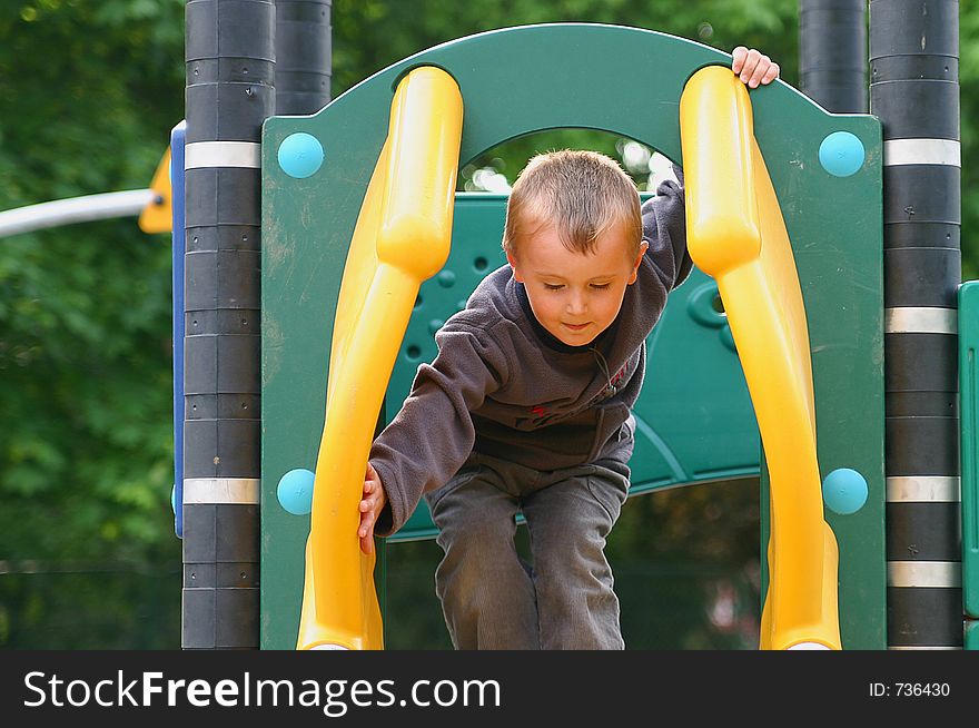 Child preparing for slide in the park. Child preparing for slide in the park