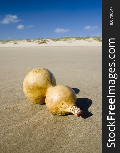 True wood bottle with sos message in beach. True wood bottle with sos message in beach