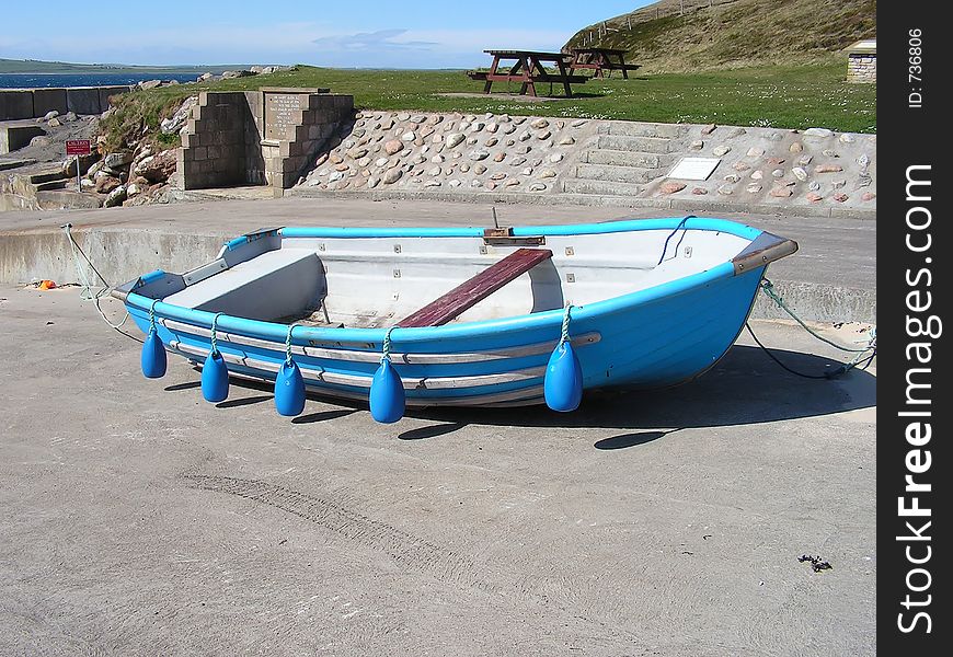 A rowing boat on the slipway of a remote pier waiting for the summer fun to begin.