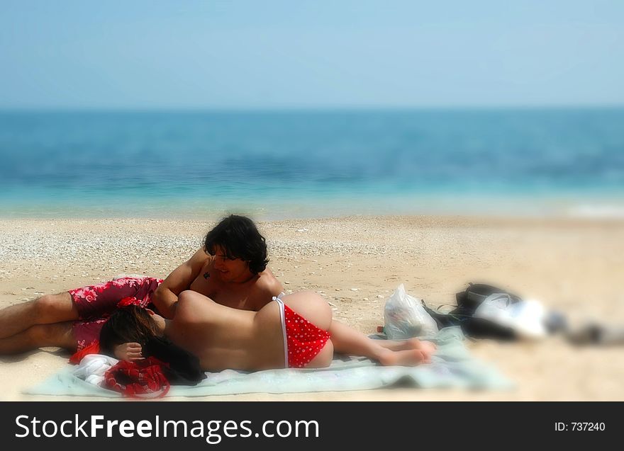 A Cute Couple Cuddles On An Italian Beach