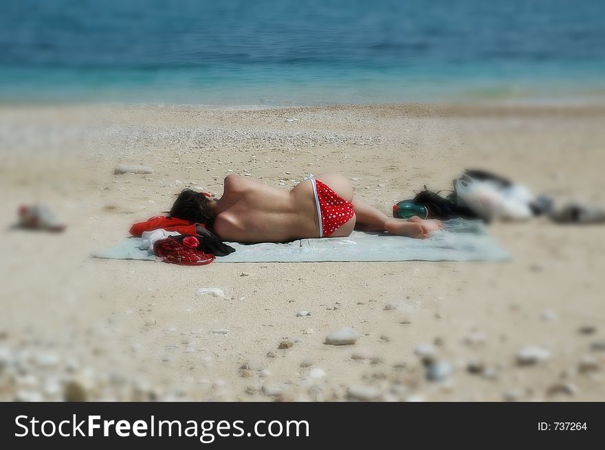 Topless Babe Takes A Nap On The Beach