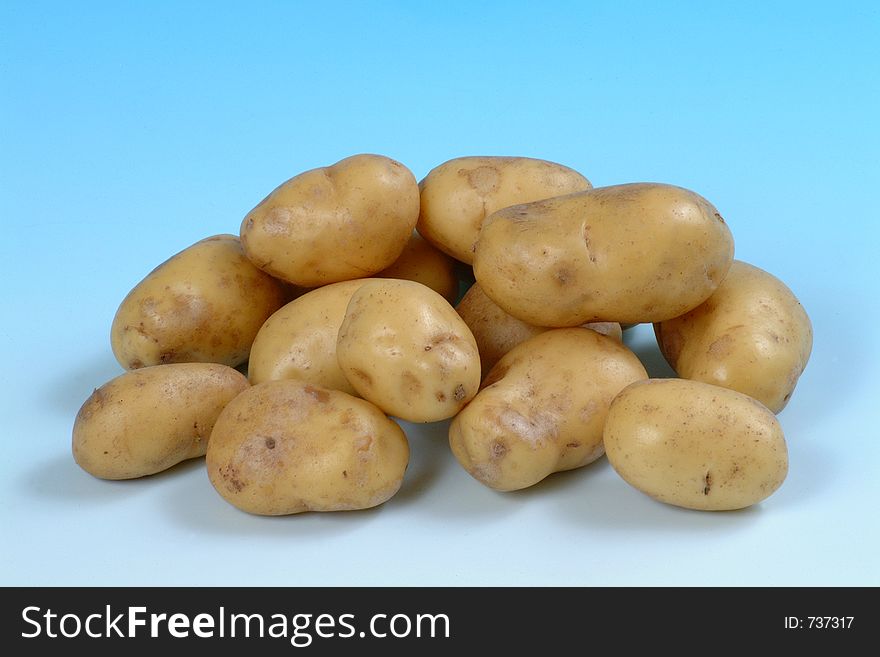 A studio image of a group of white potatoes.