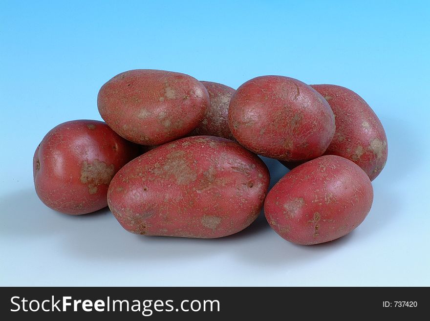 A studio image of a group of red potatoes