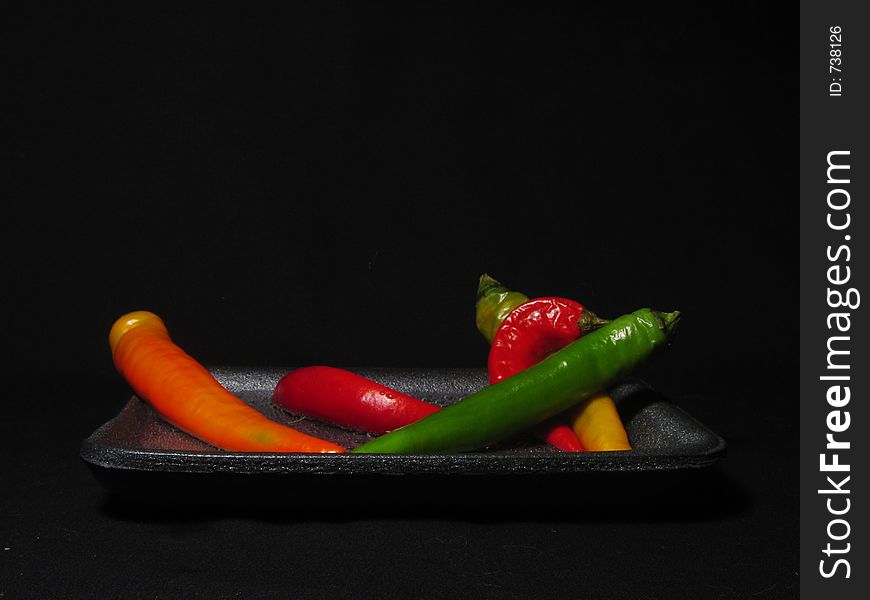 Peppers on black background