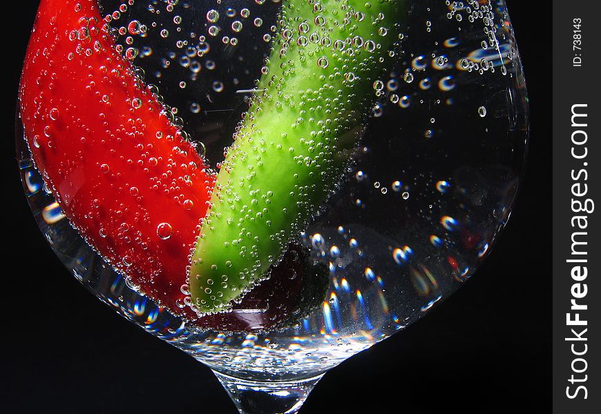 Peppers in glass with mineral water