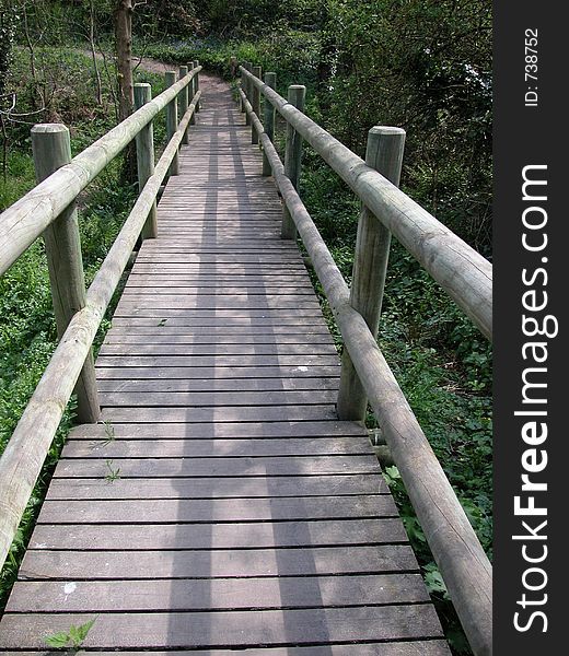 A wooden bridge constructed over a stream