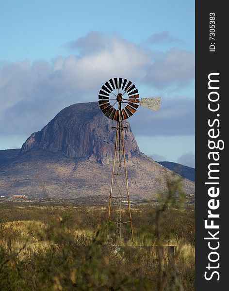 Windmill in front Mountain named Castle Rock in South Eastern Arizona. Windmill in front Mountain named Castle Rock in South Eastern Arizona