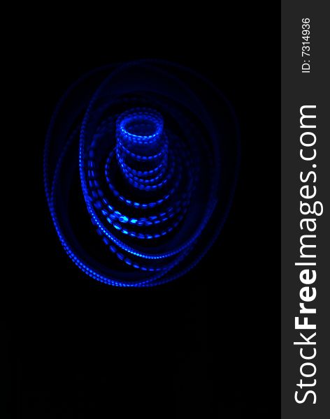 Abstarct spatial photo of blue light on black background. It looks just like abstract blue rose rising from the darkness. Abstarct spatial photo of blue light on black background. It looks just like abstract blue rose rising from the darkness.