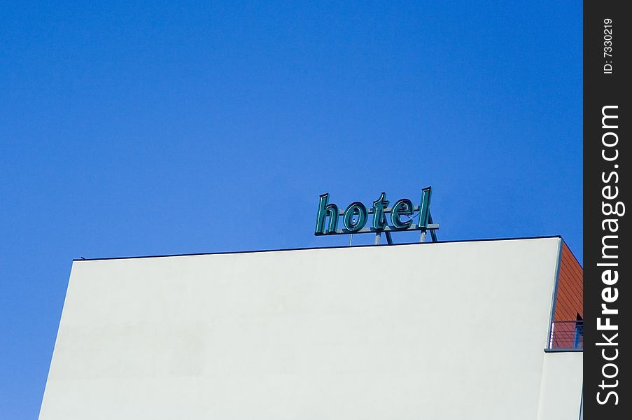 Hotel white building wall against blue clear sky. Hotel white building wall against blue clear sky