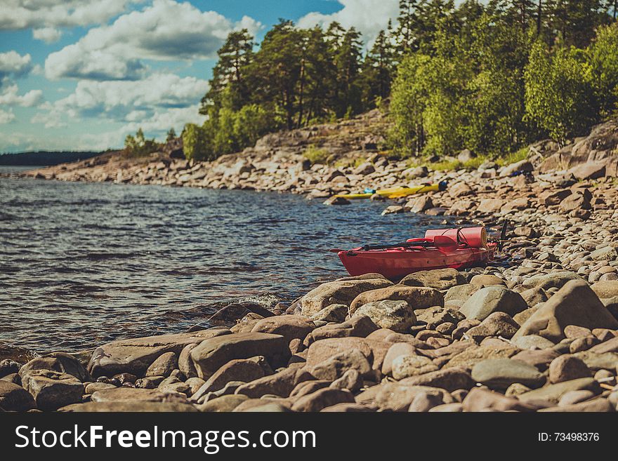 Extreme tourism on the lake. Kayaks landing on the coast. Extreme tourism on the lake. Kayaks landing on the coast