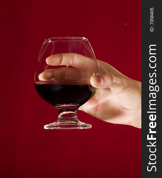 Woman's hand holding a glass of red wine