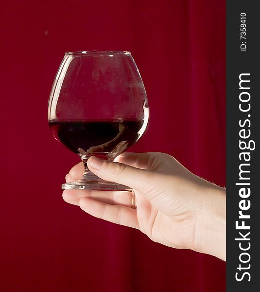 Woman's hand holding a glass of red wine