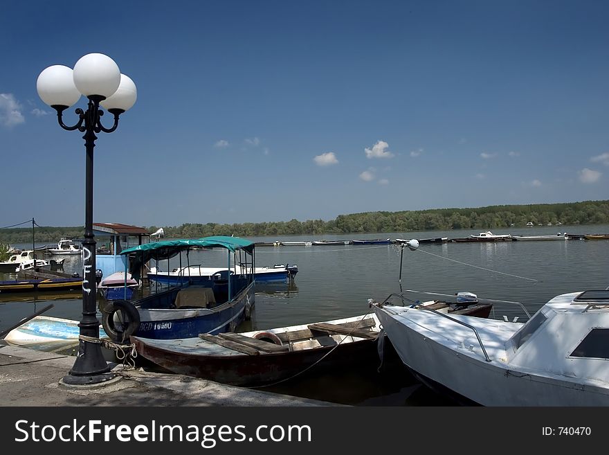 Old lamp in the riverside with sky on background