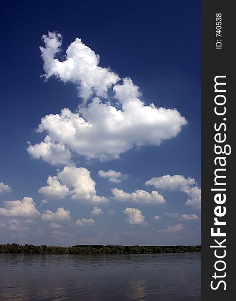 Riverscape with blue sky and white clouds