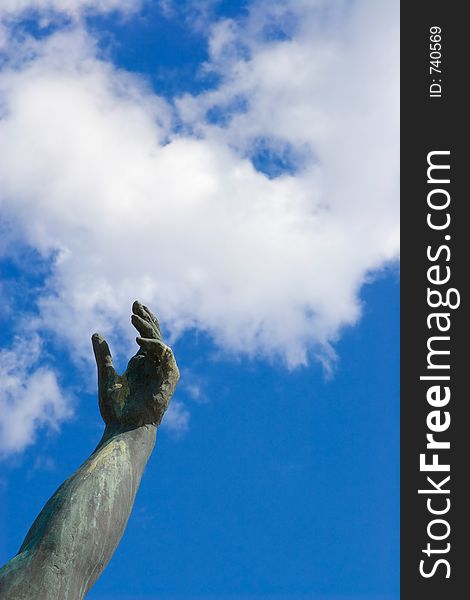 Stone hand on a background of the blue sky. Stone hand on a background of the blue sky