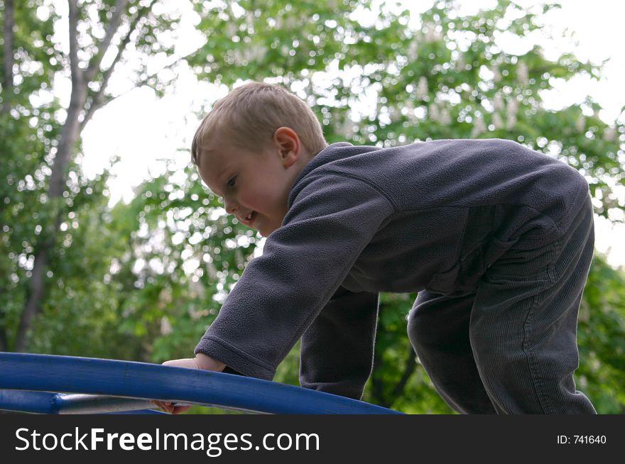 Child climbing on the park toys