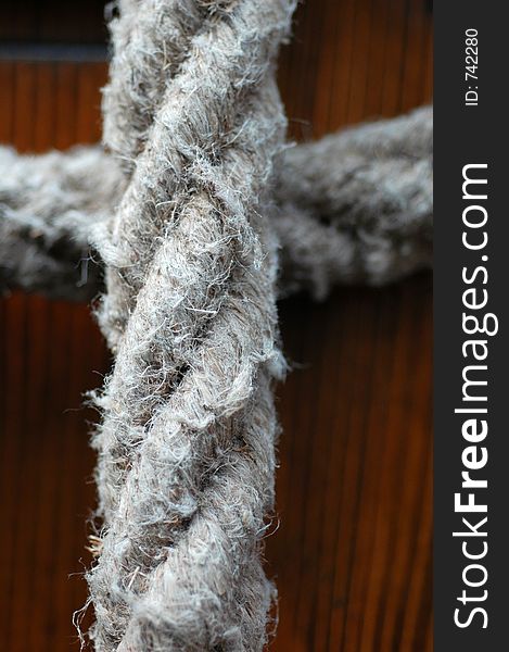 Macro of a rope, against a wooden background. Macro of a rope, against a wooden background.