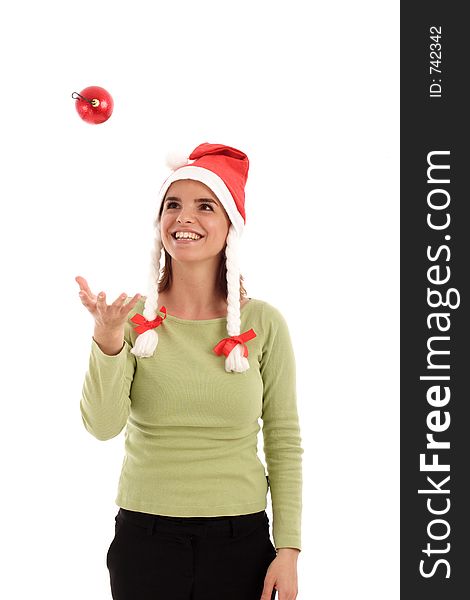 Young woman playing with red Christmas tree ornament, wearing Santa hat. Young woman playing with red Christmas tree ornament, wearing Santa hat