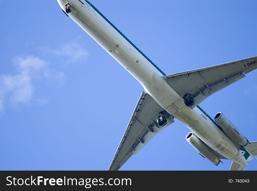 A powerfull jet is landing at Napoli International Airport, overa a deep blue sky background. A powerfull jet is landing at Napoli International Airport, overa a deep blue sky background