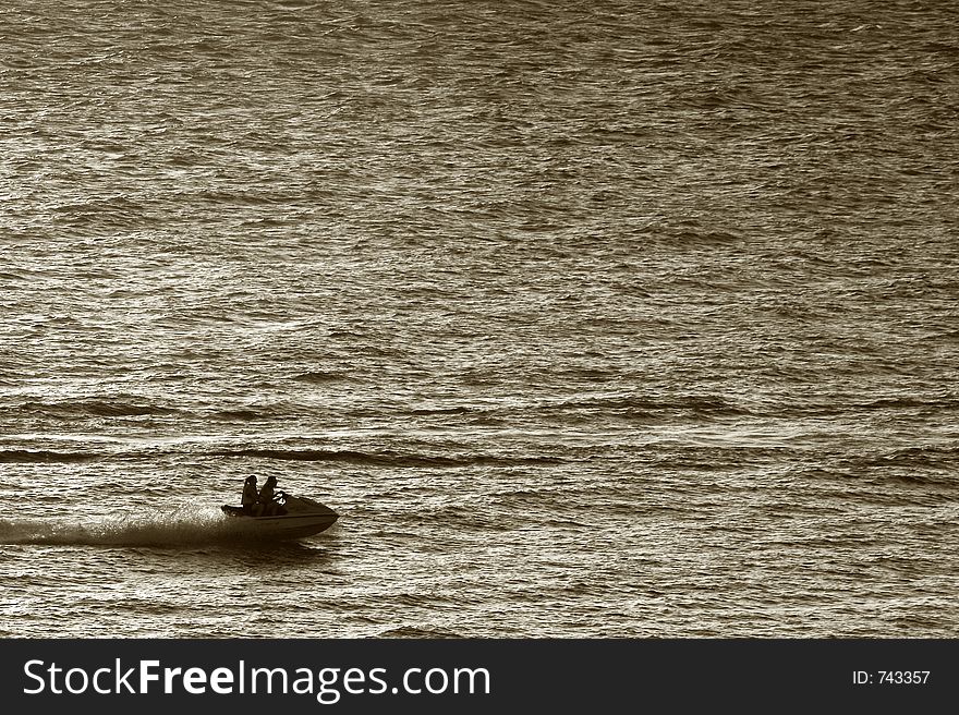 Silhouete of a wave runner on sunset(sepia)