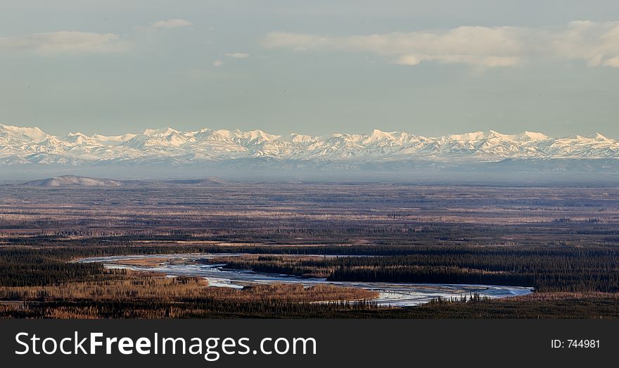 River Banding In A Valley With Mountains In The Foreground