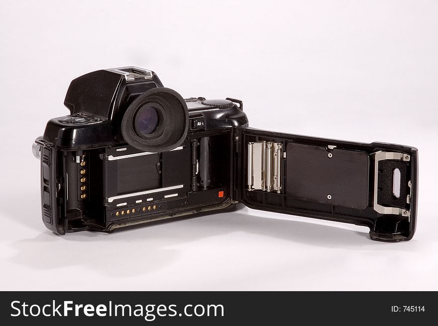 A 35mm film camera with the back open to show shutter and film transport system. A 35mm film camera with the back open to show shutter and film transport system