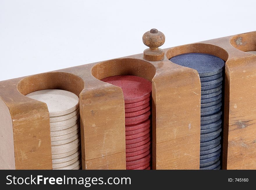 A close up of poker chips in a wooden case