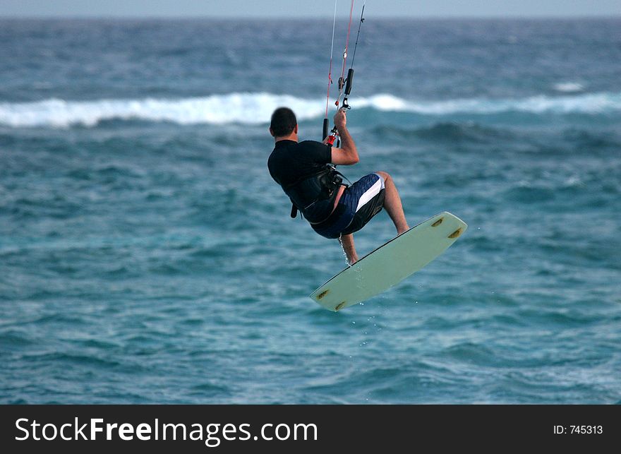 Kite surfer does an aerial. Kite surfer does an aerial.