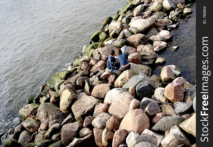 Sea,stones and couple. Sea,stones and couple