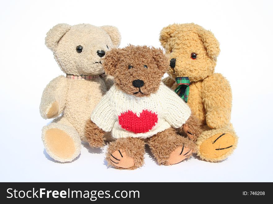 Group of teddy bears sitting on white background