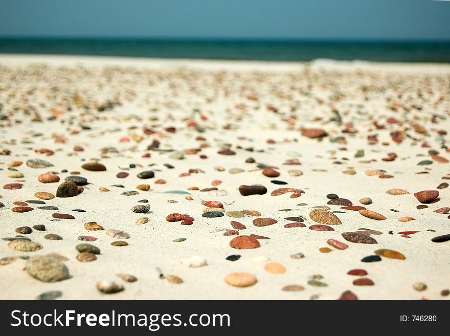 Stones on empy beach, sea in background. Stones on empy beach, sea in background