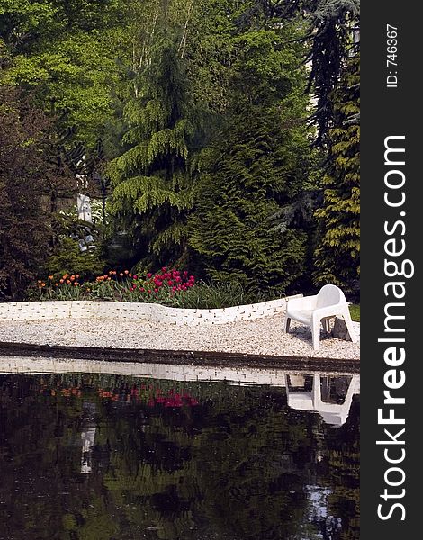 Backyard along a river with a tulip garden and bench. Backyard along a river with a tulip garden and bench